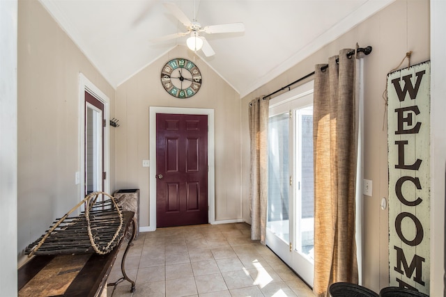 foyer entrance featuring light tile patterned floors, lofted ceiling, and a ceiling fan