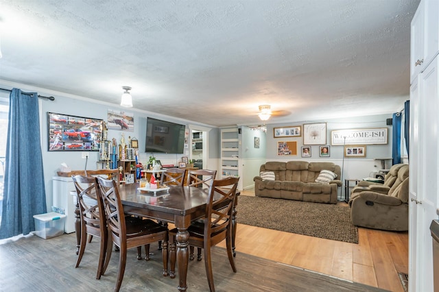 dining room featuring a textured ceiling and wood finished floors