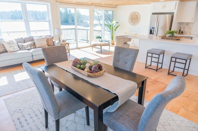 dining space with light wood-style flooring