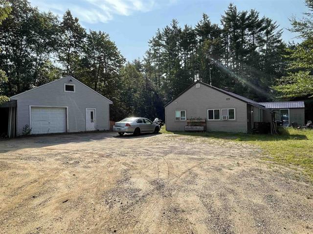 exterior space with an outbuilding, a garage, and driveway