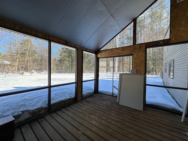 unfurnished sunroom featuring vaulted ceiling