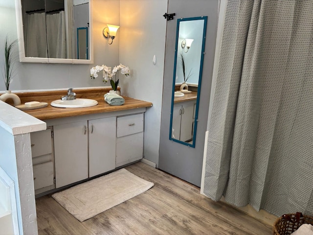 bathroom featuring vanity, a shower with curtain, and wood finished floors