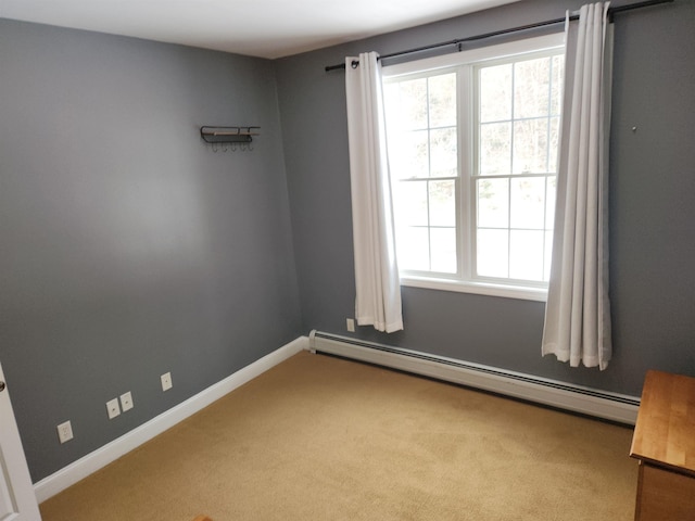 carpeted empty room with baseboards and baseboard heating