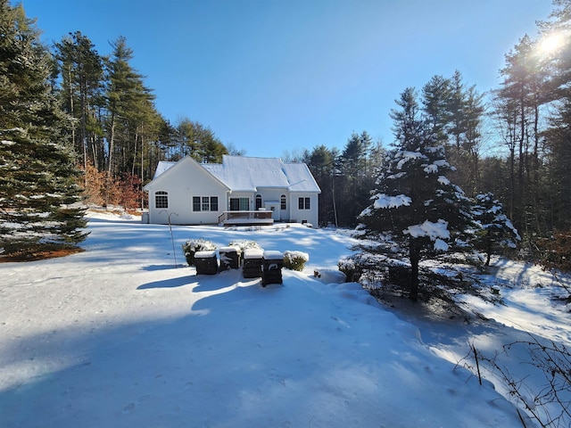 view of snow covered back of property