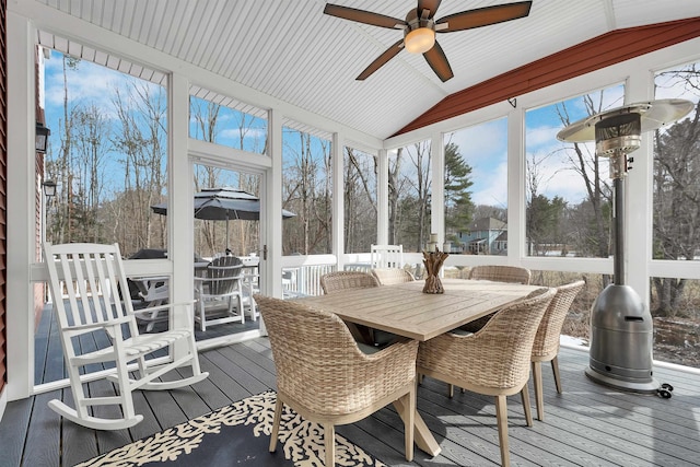 sunroom / solarium with a wealth of natural light, ceiling fan, and vaulted ceiling