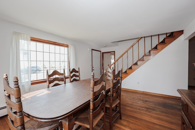 dining space with stairway, baseboards, and wood finished floors