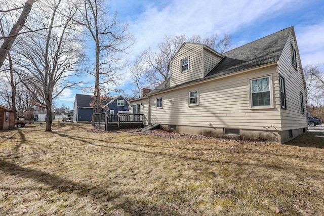 back of house with a wooden deck and roof with shingles