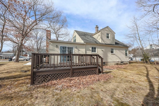 back of property featuring a wooden deck and a chimney