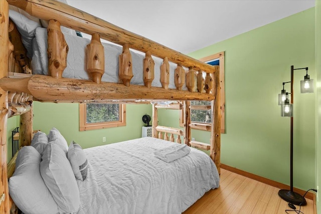 bedroom with baseboards and wood finished floors