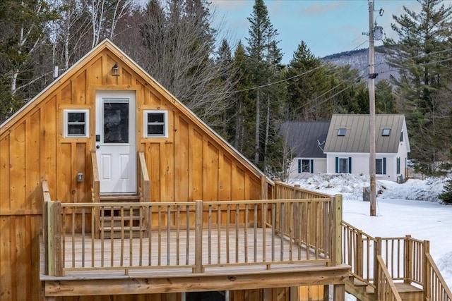 snow covered deck featuring entry steps