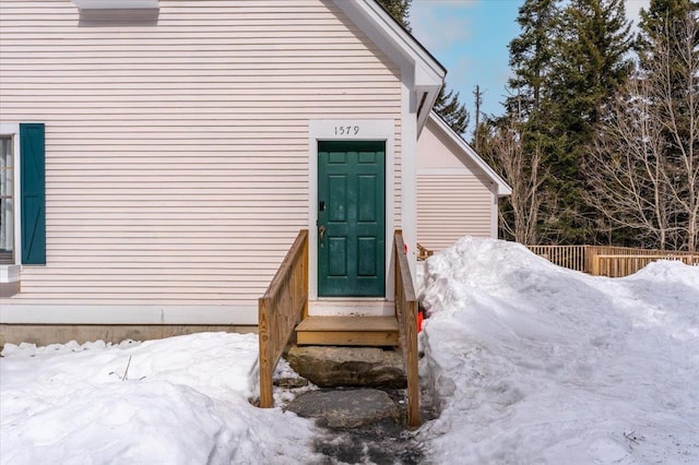 view of snow covered property entrance