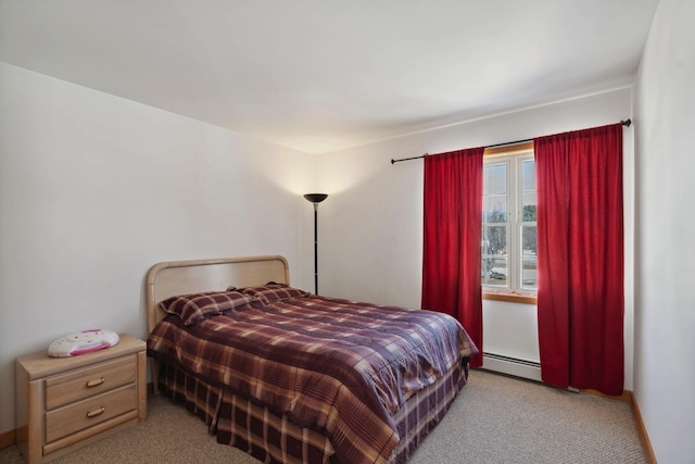 carpeted bedroom featuring baseboard heating