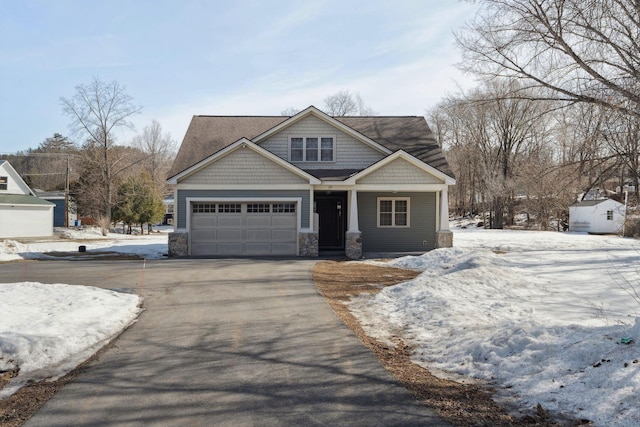 craftsman house with stone siding and driveway