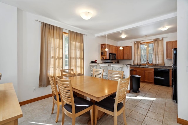 dining space featuring light tile patterned floors and baseboards