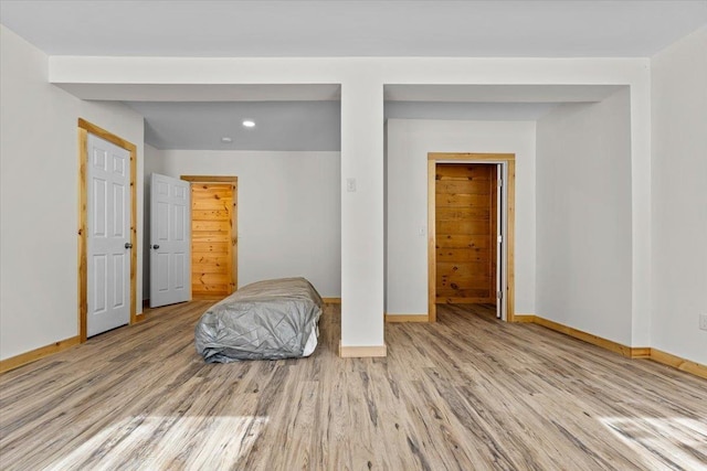 bedroom with baseboards and wood finished floors