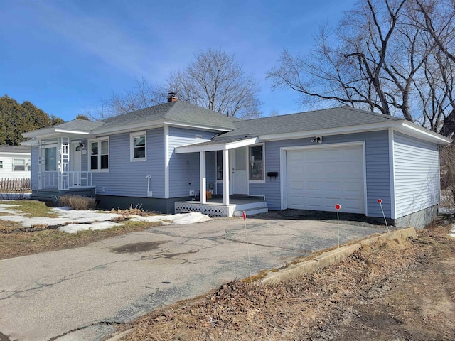 view of front of home with covered porch, an attached garage, a shingled roof, and driveway