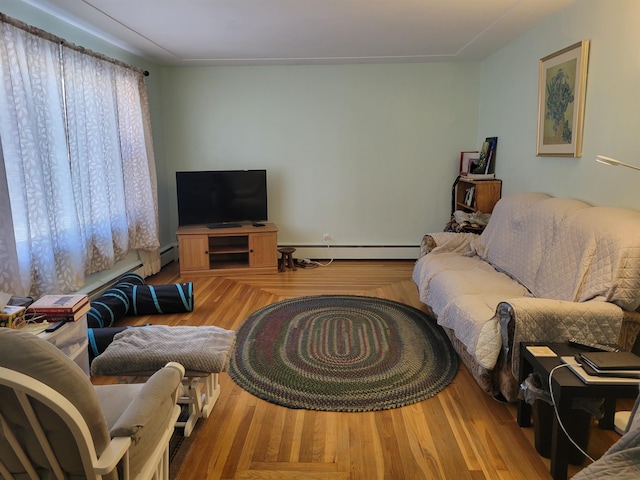 living area with wood finished floors and a baseboard radiator