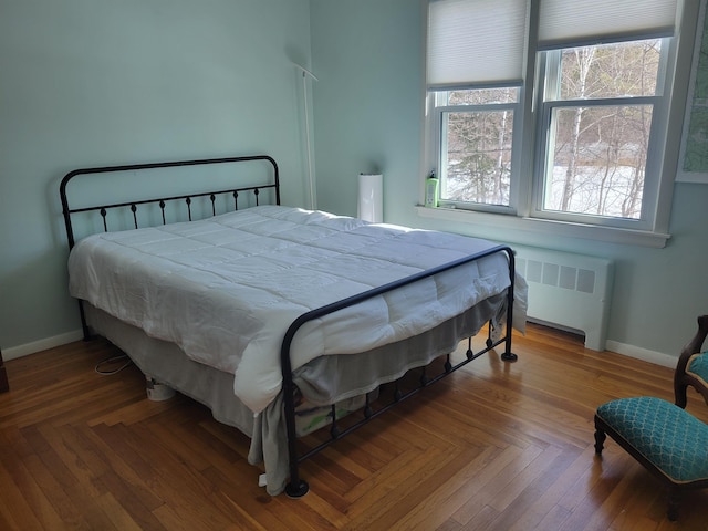 bedroom with radiator and baseboards