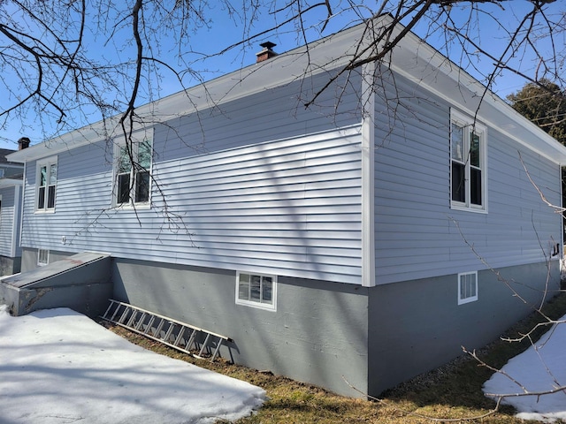 view of property exterior featuring a chimney