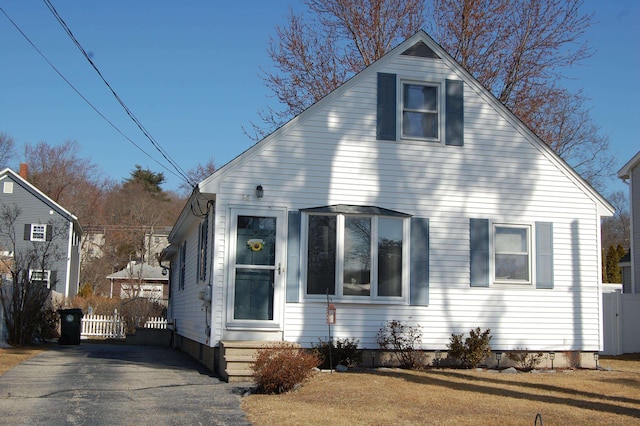 bungalow-style home with fence