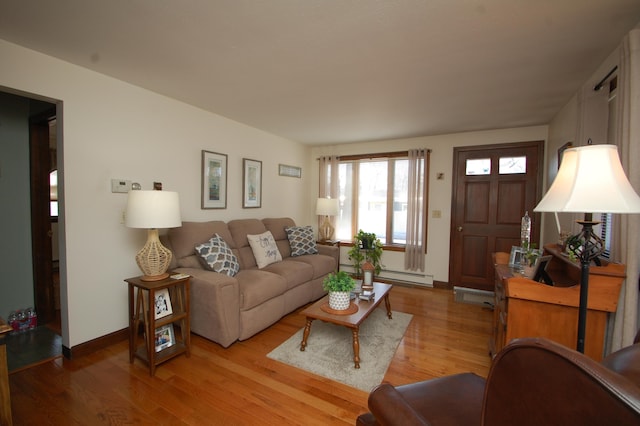 living area with light wood finished floors, baseboards, and a baseboard radiator