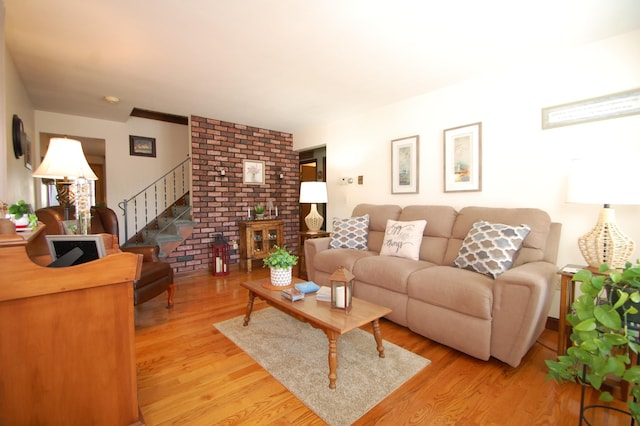 living area featuring stairway and light wood-type flooring