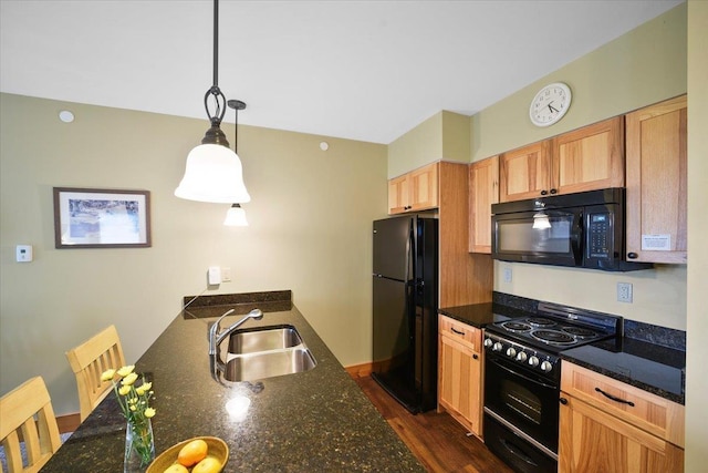 kitchen featuring a peninsula, a sink, black appliances, dark wood-type flooring, and decorative light fixtures