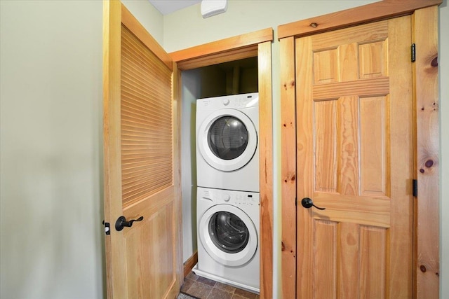 clothes washing area with laundry area and stacked washing maching and dryer