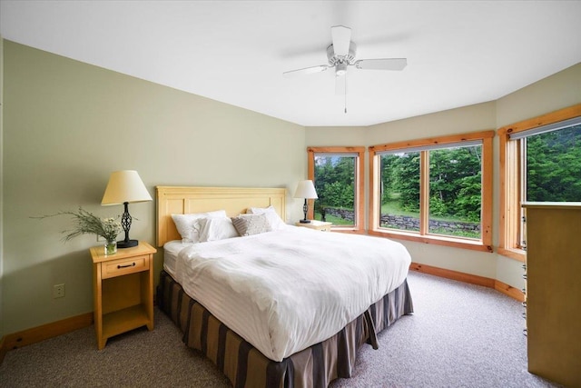 carpeted bedroom featuring a ceiling fan and baseboards