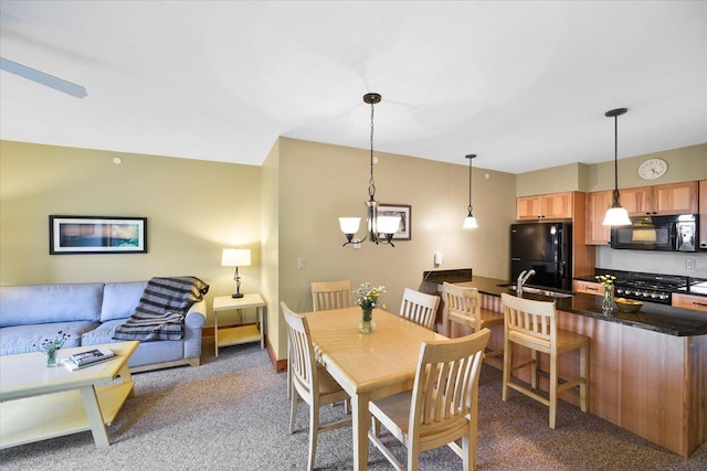 dining space featuring carpet and a chandelier