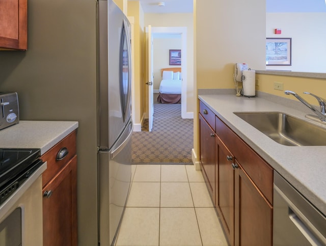 kitchen featuring light countertops, stainless steel appliances, and a sink