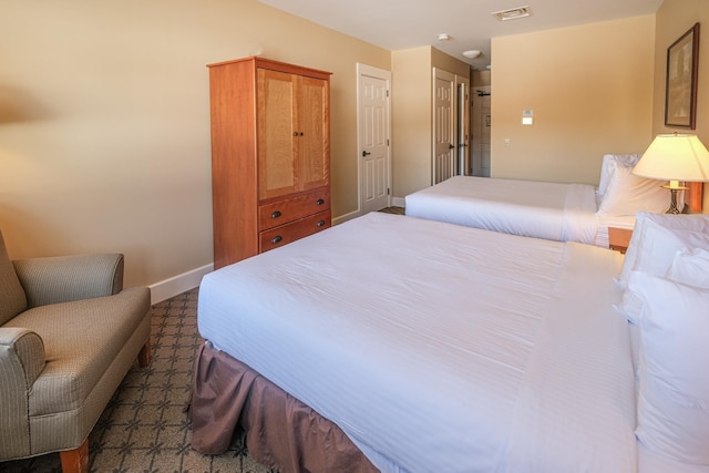 bedroom featuring visible vents and baseboards