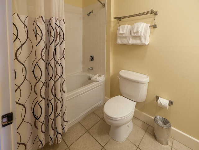 full bathroom with baseboards, toilet, shower / bath combo, and tile patterned flooring