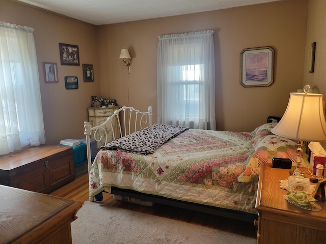 bedroom with wood finished floors