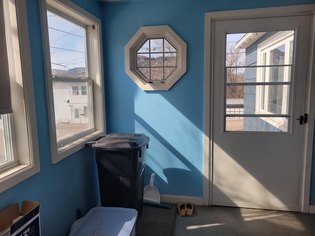 doorway featuring baseboards