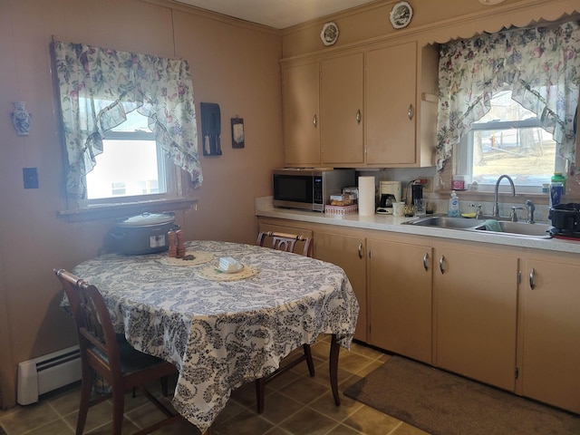 dining room featuring light tile patterned floors and a baseboard radiator