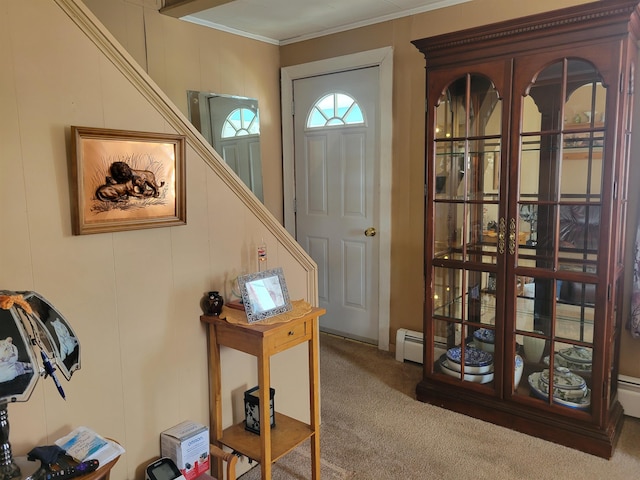 foyer entrance featuring a baseboard heating unit, crown molding, stairway, and carpet