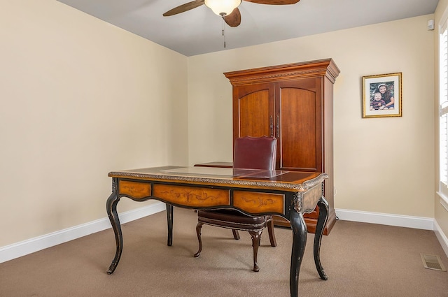 carpeted office featuring visible vents, baseboards, and ceiling fan