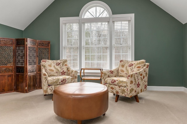 living area with plenty of natural light, carpet, and lofted ceiling