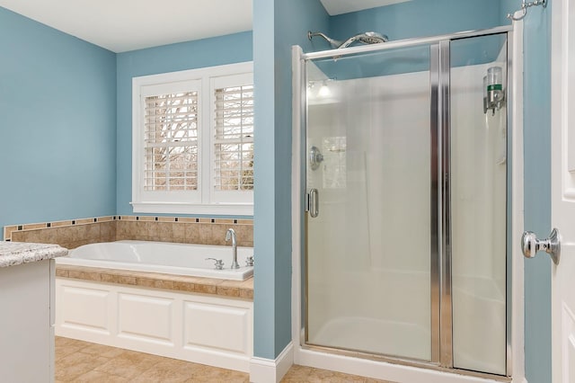 bathroom featuring a shower stall and a garden tub