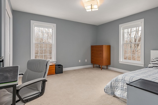 bedroom featuring multiple windows, carpet floors, and baseboards