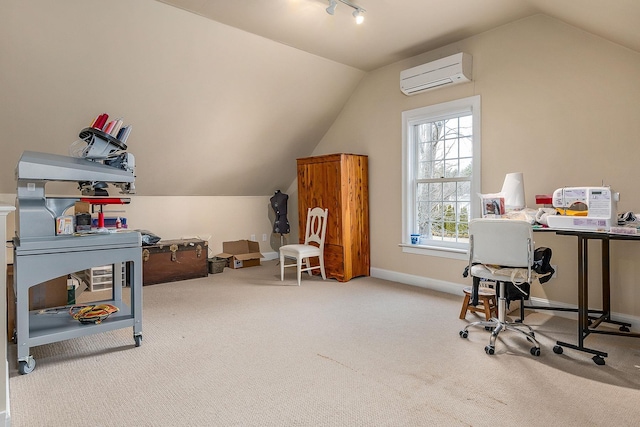 office featuring a wall mounted air conditioner, lofted ceiling, track lighting, carpet flooring, and baseboards