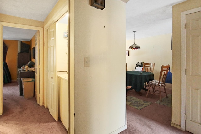 hallway featuring light colored carpet