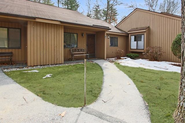 chalet / cabin with a front lawn