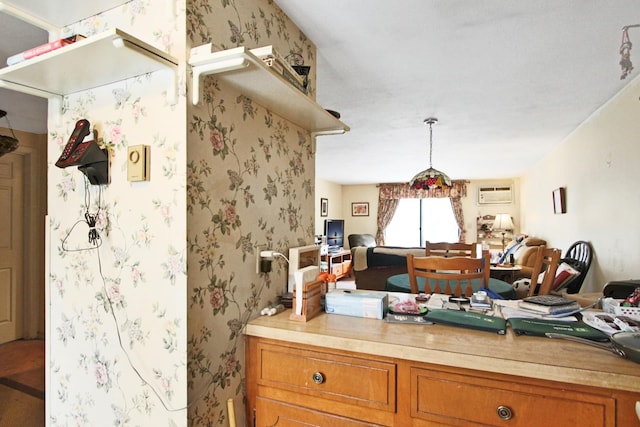 kitchen featuring brown cabinets, open floor plan, light countertops, and wallpapered walls