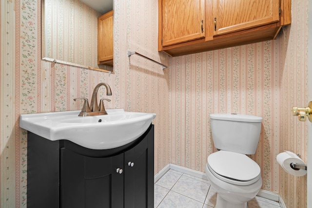 bathroom with wallpapered walls, baseboards, toilet, tile patterned floors, and vanity