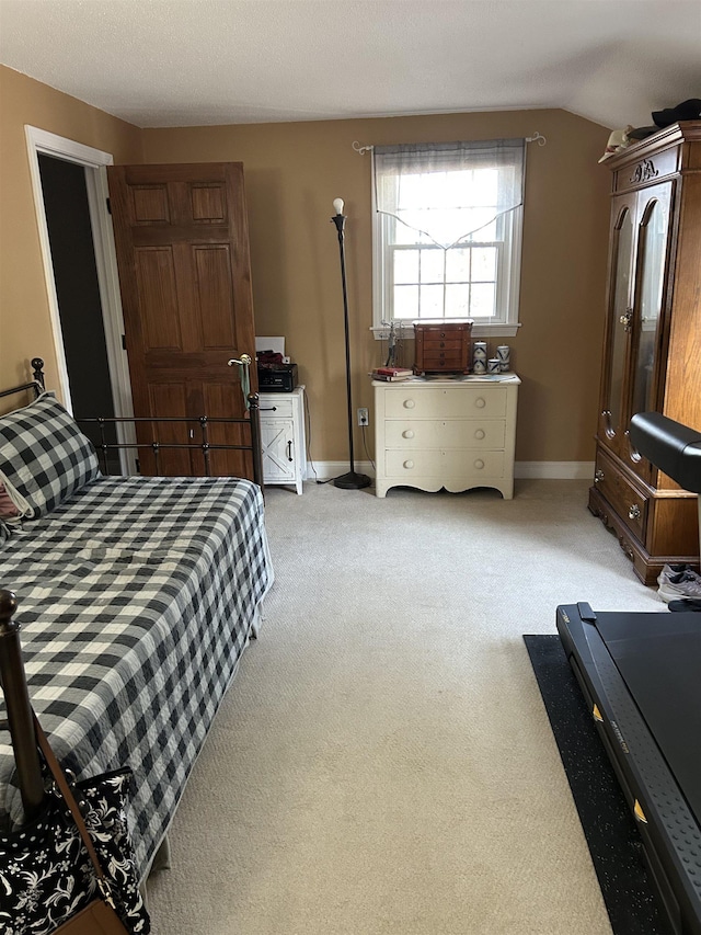 bedroom with baseboards, light colored carpet, and lofted ceiling