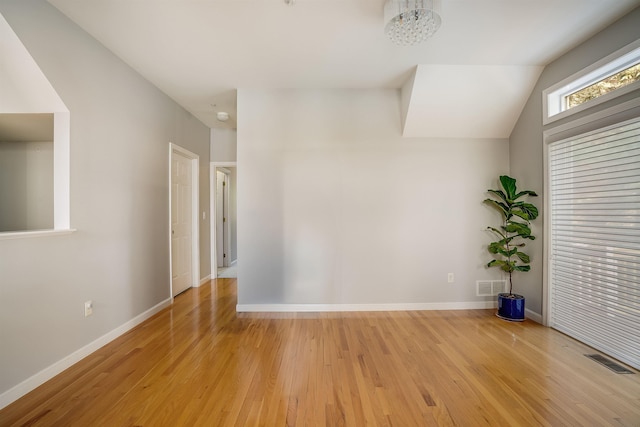 empty room with visible vents, baseboards, and light wood-style flooring