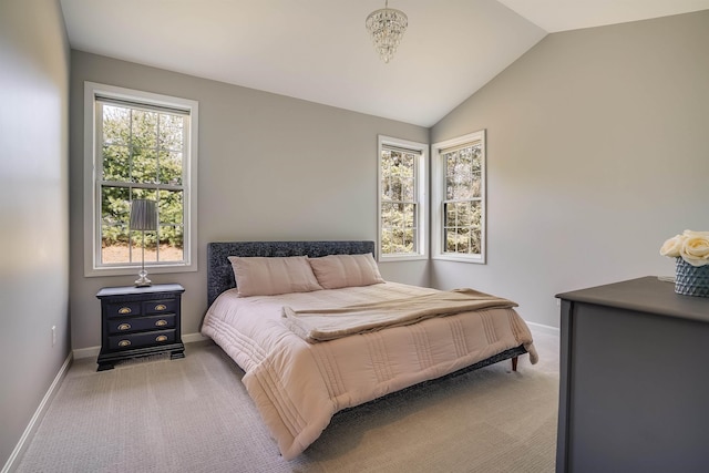 bedroom with lofted ceiling, baseboards, and carpet floors