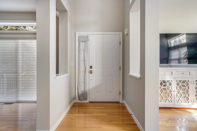 entryway with light wood-style flooring, visible vents, and baseboards